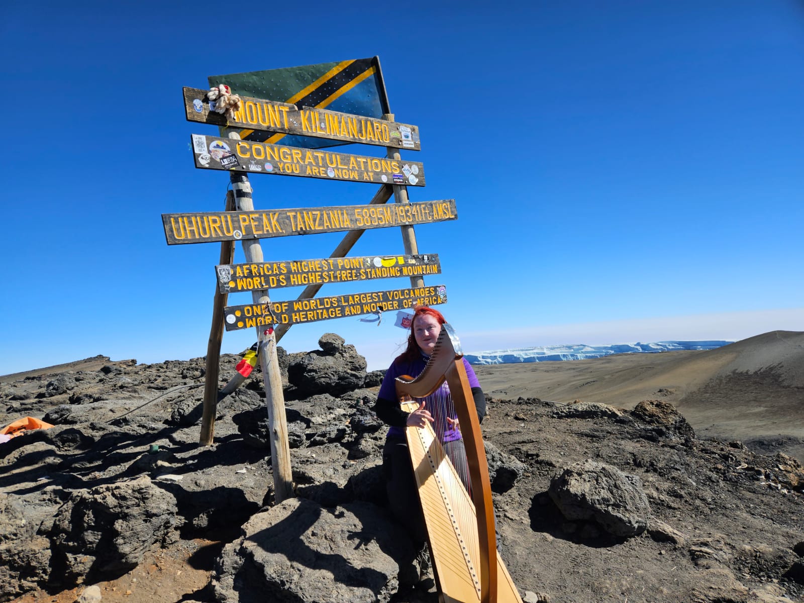 24-year-old Siobhan Brady on the summit of Mount Kilimanjaro on the morning of 25th July 2023, during the Guinness World Record attempt, for the Highest Harp Concert, raising funds for Cystic Fibrosis Ireland.